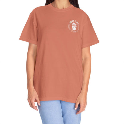 terracotta color shirt with a happy plant club logo on it 